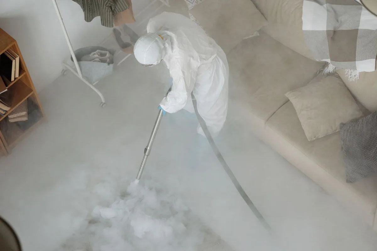 Biohazard cleanup technician in protective equipment, West Village, New York, NY
